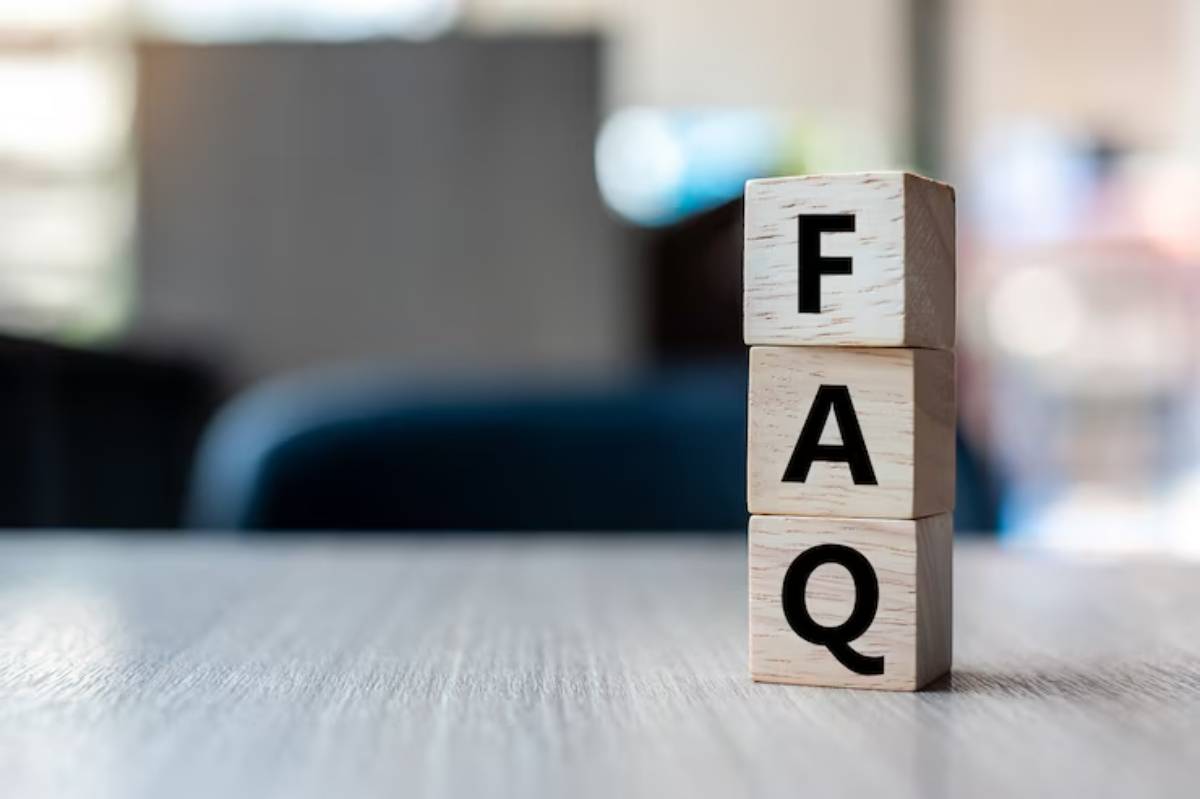 Wooden blocks stack display the letters F, A, and Q, symbolizing frequently asked questions, on a blurred background.