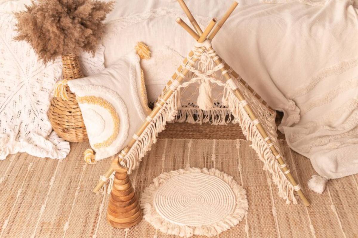 A cozy, bohemian-style play area featuring a woven teepee, decorative pillows, and natural fiber rugs in warm, neutral tones.